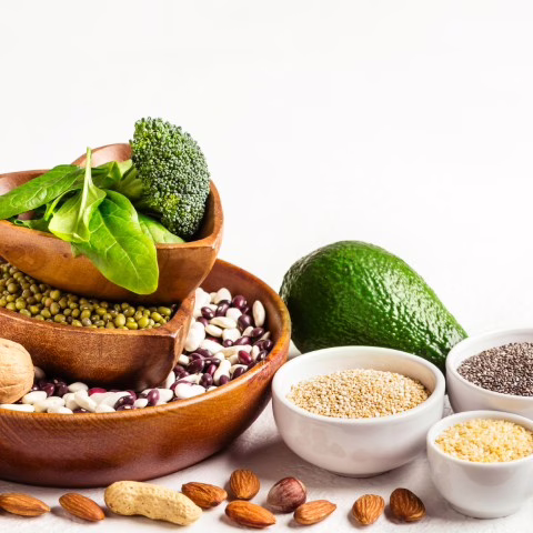 Sources of vegetable protein. Bowls with beans and nuts on a white background.